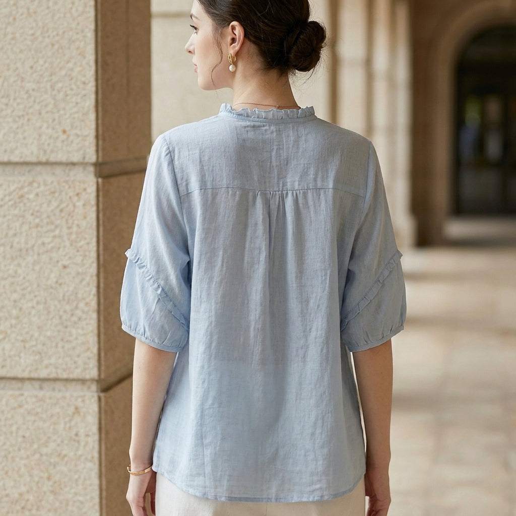 Back view of Christine Brewer women's linen summer blouse with ruffle details, lightweight and stylish women's top.