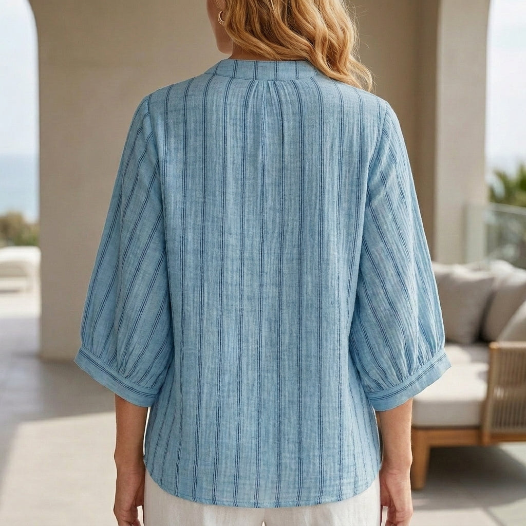 Back view of Christine Brewer women's striped linen summer blouse with button front, casual top for warm weather.