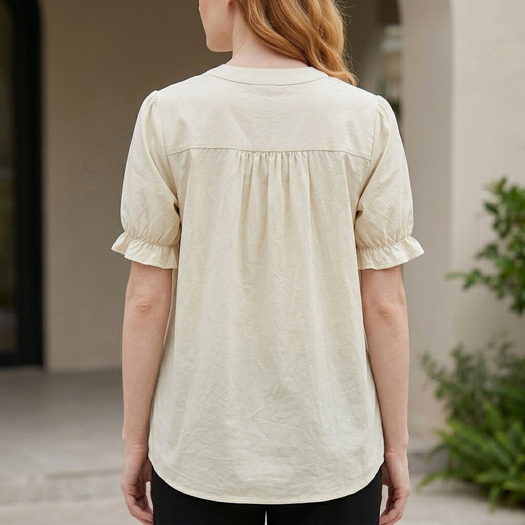 Back view of Christine Brewer women's summer blouse with puff sleeves, denim fabric, and button-front design.