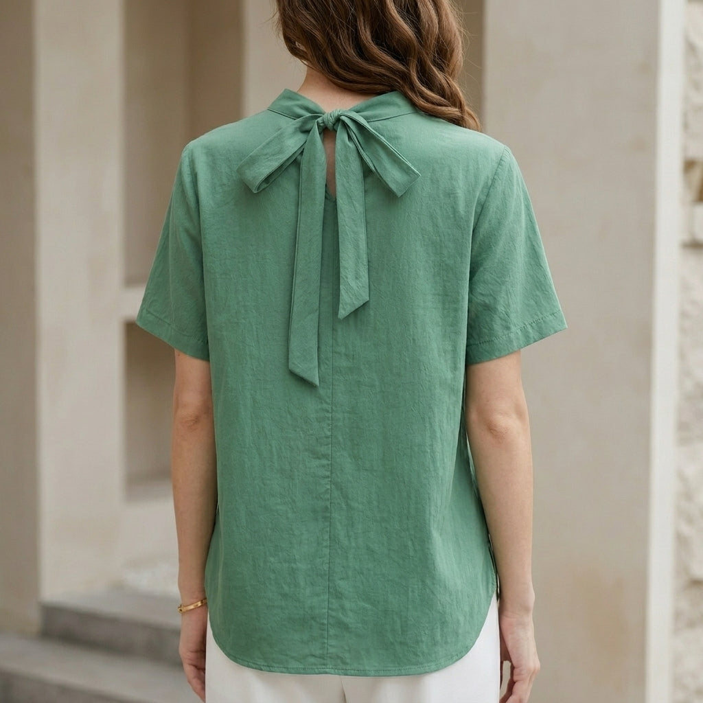 Back view of Christine Brewer summer blouse for women, high neck short sleeve top in lightweight fabric.