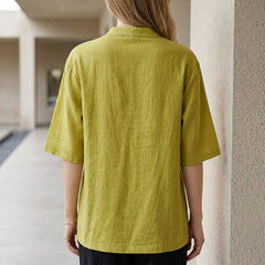Back view of Christine Brewer women's summer denim blouse with chest pockets, casual top for warm weather.