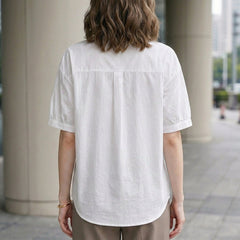 Back view of Christine Brewer women's summer blouse with puff sleeves, denim fabric, button front, casual style.