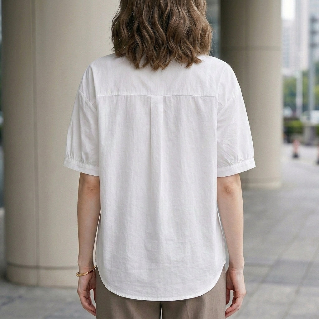 Back view of Christine Brewer women's summer blouse with puff sleeves, denim fabric, button front, casual style.