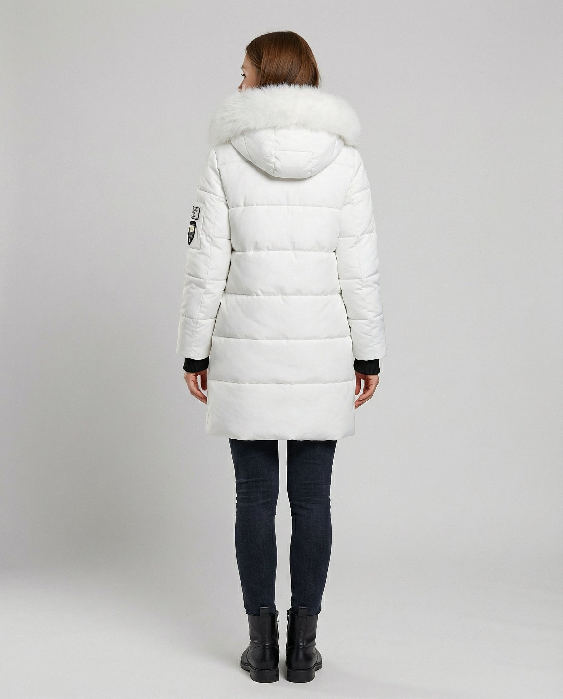 Back view of Christine Brewer Sadie women's cosy puffer jacket in black, featuring a quilted design and hood for warmth and comfort.