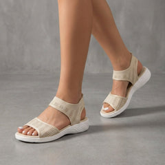 Beige knit ankle-strap sandals for women by Christine Brewer, featuring open toes and stylish ankle straps.