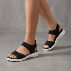 Black knit ankle-strap sandals for women, Christine Brewer brand, showcasing a stylish open-toe design with ankle straps.
