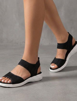Black knit ankle-strap sandals for women, Christine Brewer brand, showcasing a stylish open-toe design with ankle straps.