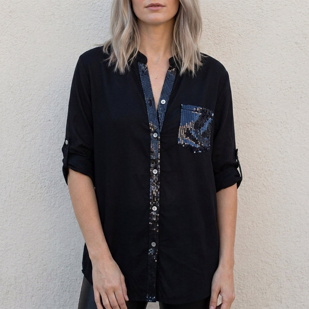 Black women's summer blouse with V-neck, denim fabric, and button front by Christine Brewer, displayed on a hanger.