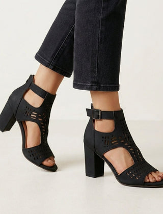 Black women's cut-out block-heel sandals with ankle buckle by Christine Brewer, showcasing stylish design and comfortable fit.
