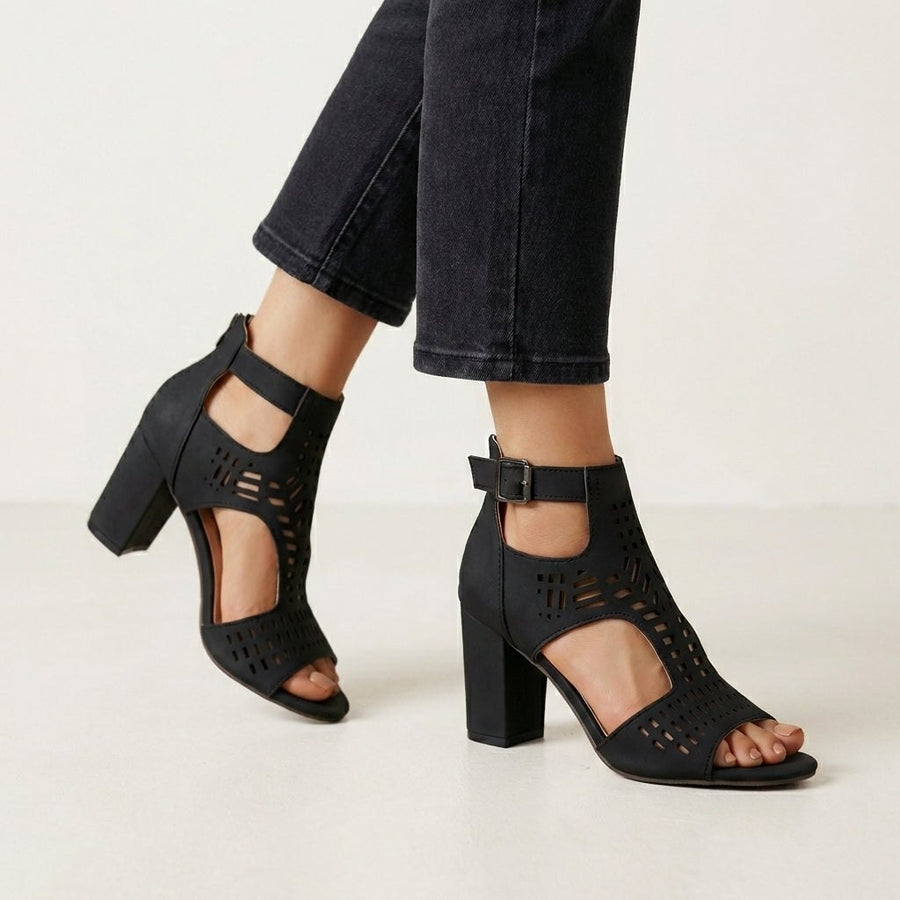 Black women's cut-out block-heel sandals with ankle buckle by Christine Brewer, showcasing stylish design and comfortable fit.