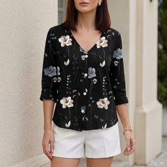 Black floral V-neck summer blouse for women by Christine Brewer, featuring denim buttons and a relaxed fit.