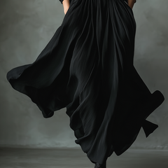 Black pleated maxi dress for women by Christine Brewer, featuring flowing fabric and elegant design, shown on a model.