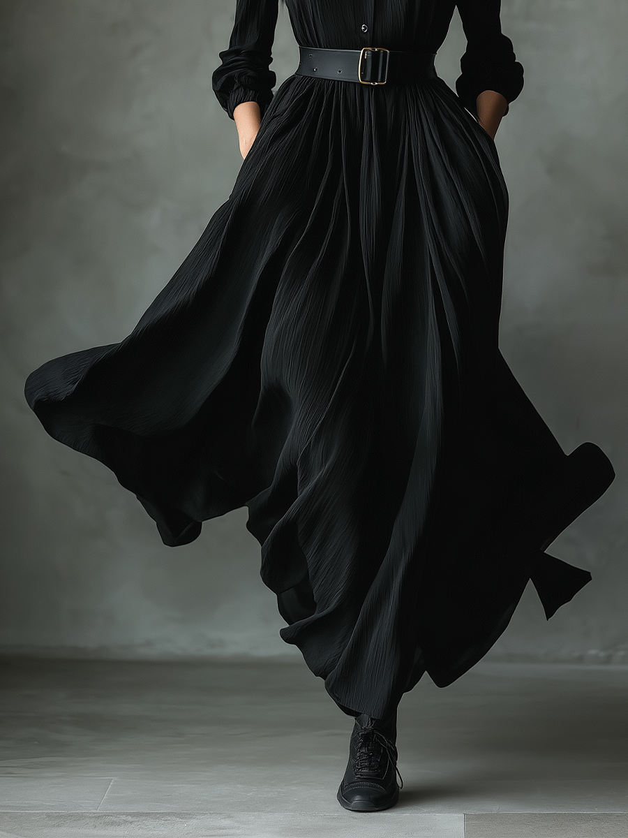 Black pleated maxi dress for women by Christine Brewer, featuring flowing fabric and elegant design, shown on a model.