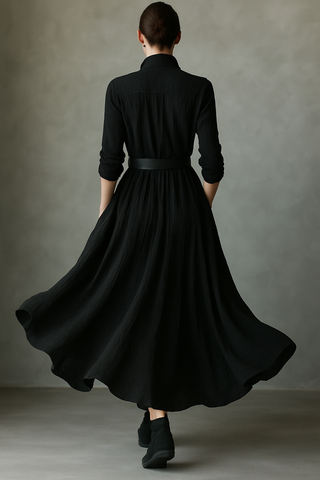 Black pleated maxi dress for women by Christine Brewer, featuring flowing fabric and elegant design, shown on a model.