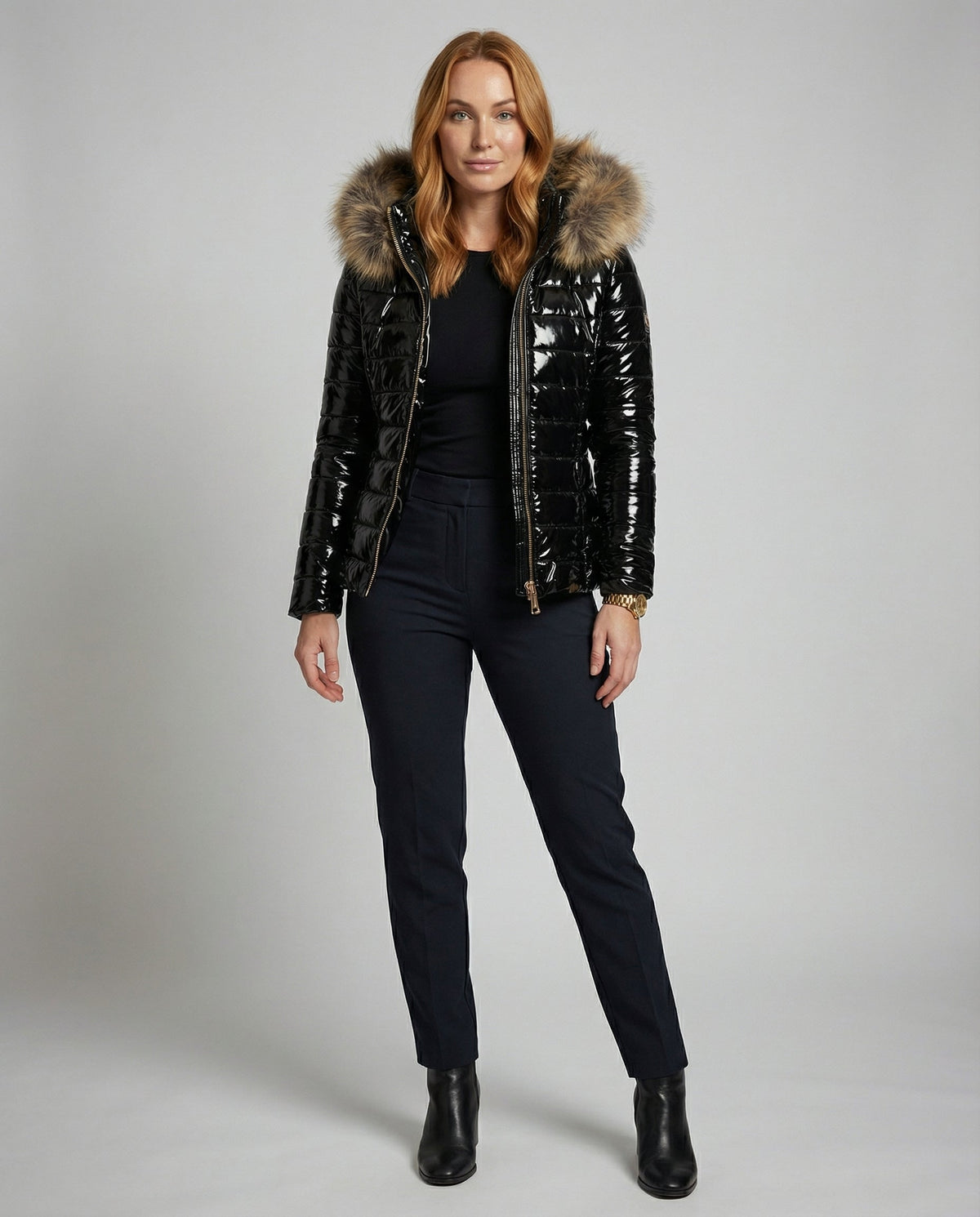 Black Delilah hooded puffer jacket for women by Christine Brewer, full-body front view, stylish winter outerwear.