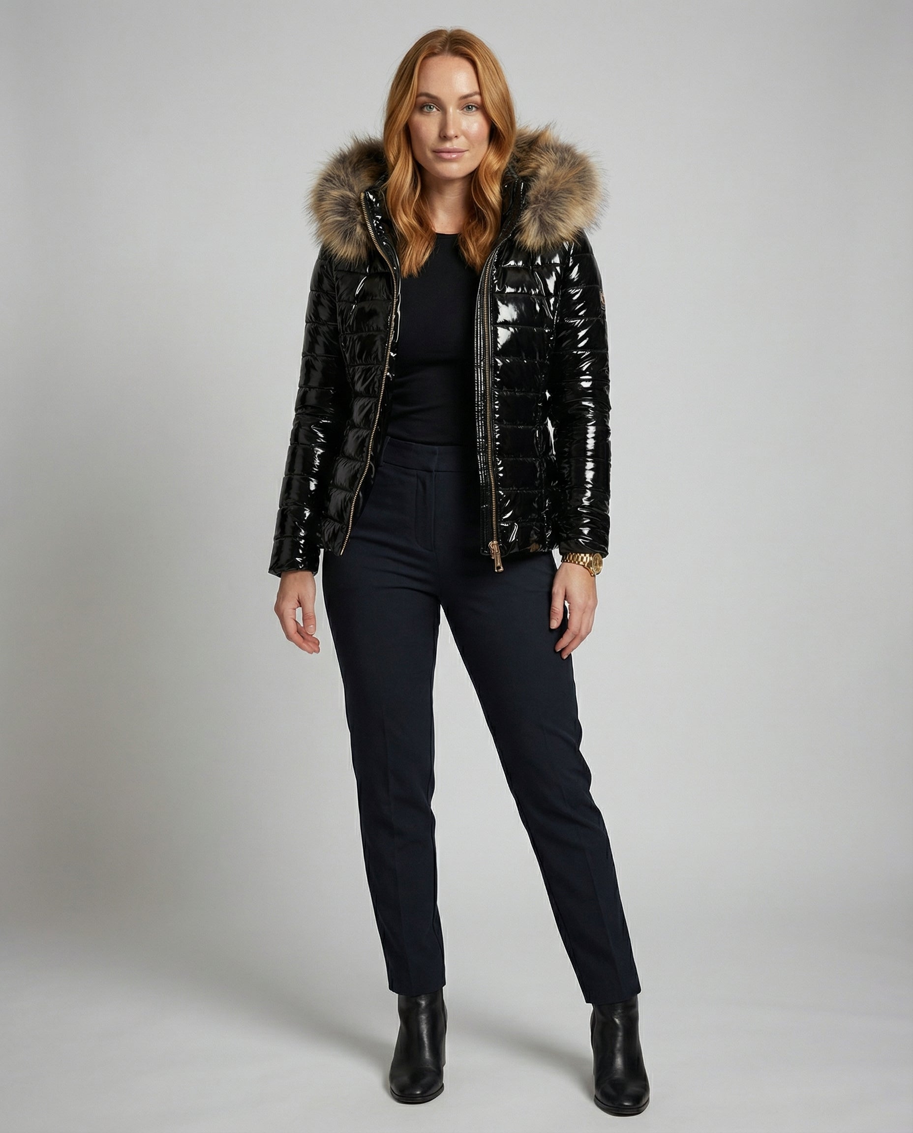 Black Delilah hooded puffer jacket for women by Christine Brewer, full-body front view, stylish winter outerwear.