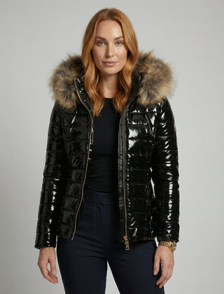 Black hooded puffer jacket for women from Christine Brewer, shown on a woman with the jacket's upper body details visible.