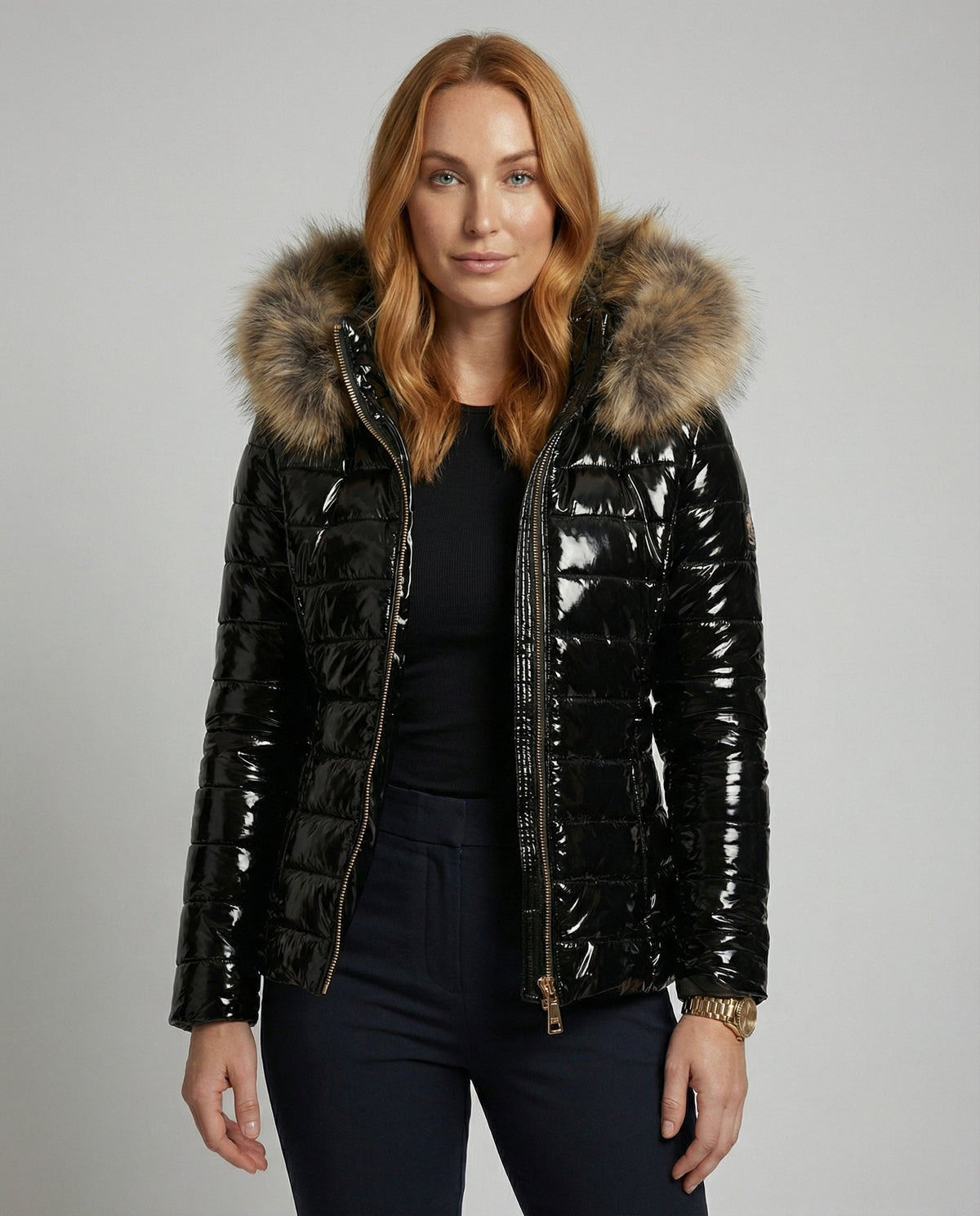 Black hooded puffer jacket for women from Christine Brewer, shown on a woman with the jacket's upper body details visible.