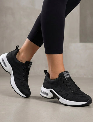 Black knit sneakers for women by Christine Brewer, showcasing comfortable, stylish women's shoes with a textured knit upper.