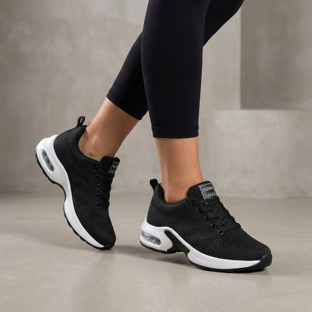 Black knit sneakers for women by Christine Brewer, showcasing comfortable, stylish women's shoes with a textured knit upper.
