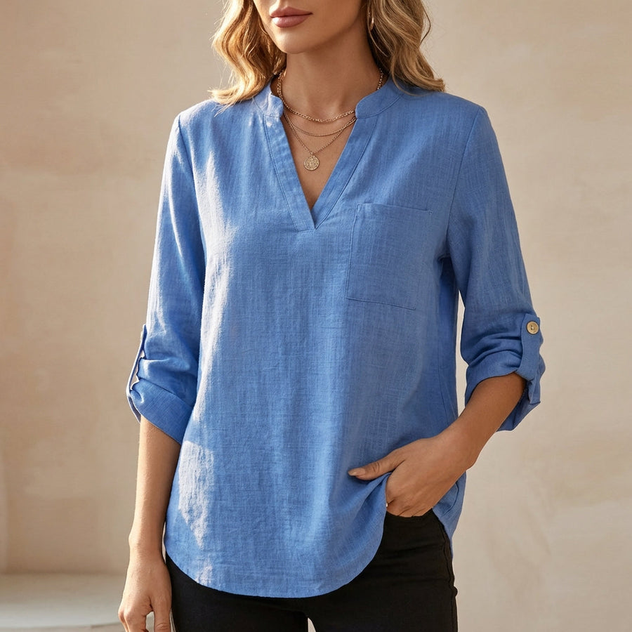 Blue women's summer blouse by Christine Brewer featuring a V-neck and flowy linen fabric, perfect for warm weather.