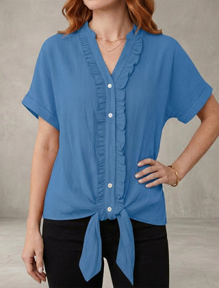 Blue V-neck denim summer blouse for women with ruffle details, casual style by Christine Brewer, shown on model.