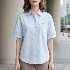 Blue denim summer blouse for women with puff sleeves and button front, casual style by Christine Brewer.