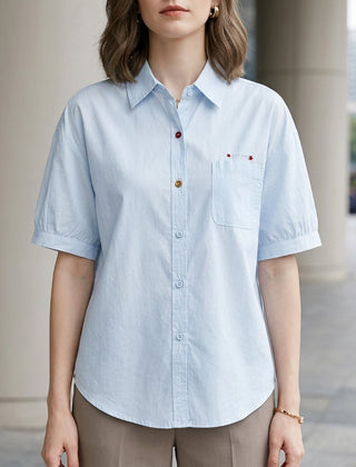 Blue denim summer blouse for women with puff sleeves and button front, casual style by Christine Brewer.