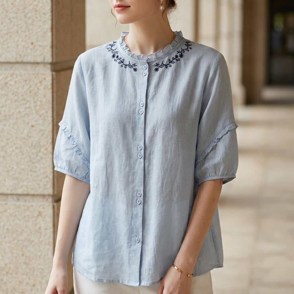 Blue linen ruffle summer blouse for women, stylish top from Christine Brewer with feminine details and lightweight fabric.