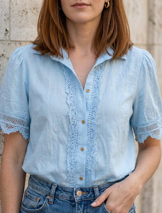 Blue women's summer blouse by Christine Brewer with V-neck, short sleeves, and lace detail.