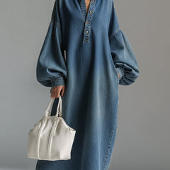 Blue denim maxi dress by Christine Brewer featuring a relaxed fit, sleeveless design, and flowing length perfect for evening wear.