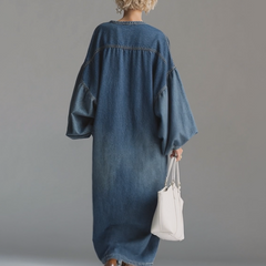 Blue denim maxi dress by Christine Brewer featuring a flowing silhouette and sleeveless design for evening wear.