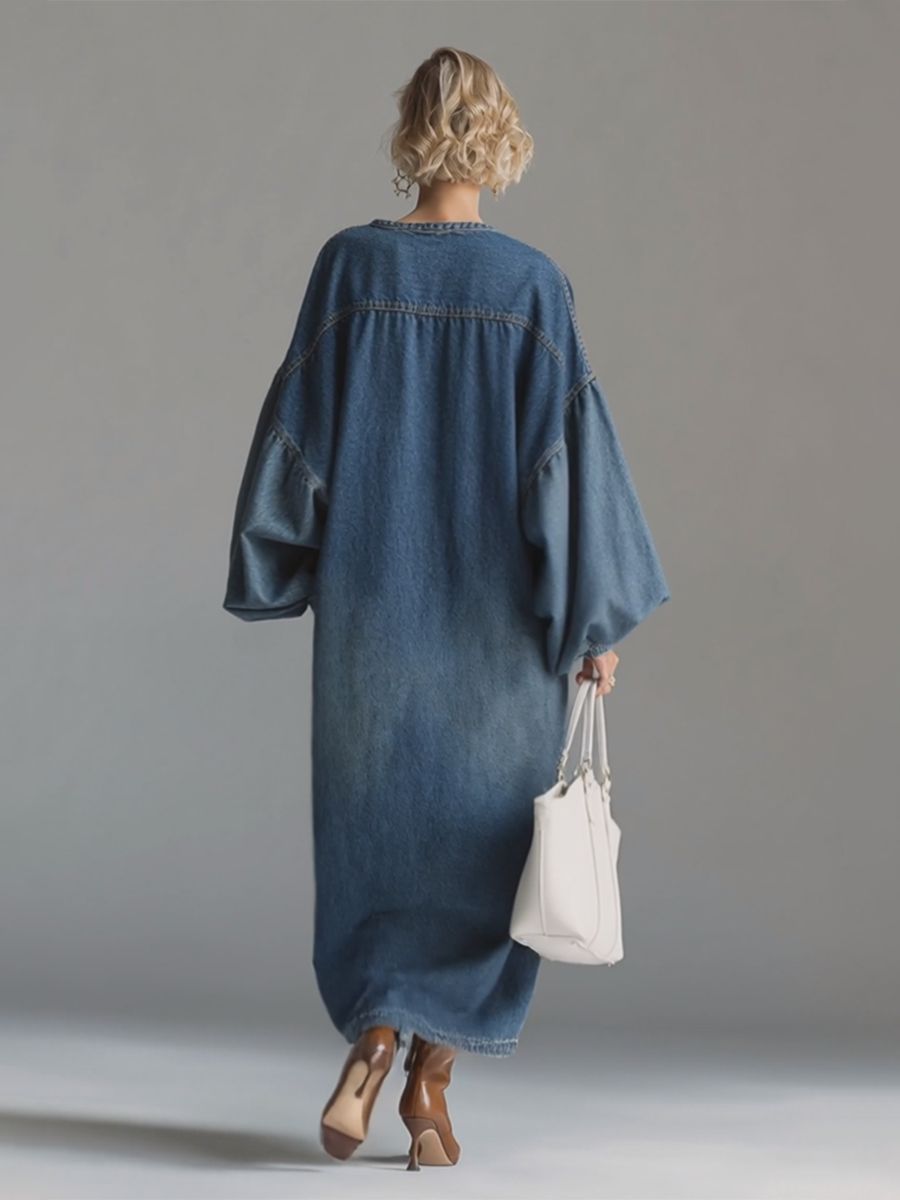 Blue denim maxi dress by Christine Brewer featuring a flowing silhouette and sleeveless design for evening wear.