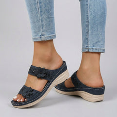 Blue floral strap wedge heeled sandals for women by Christine Brewer, featuring a stylish design and comfortable heel height.