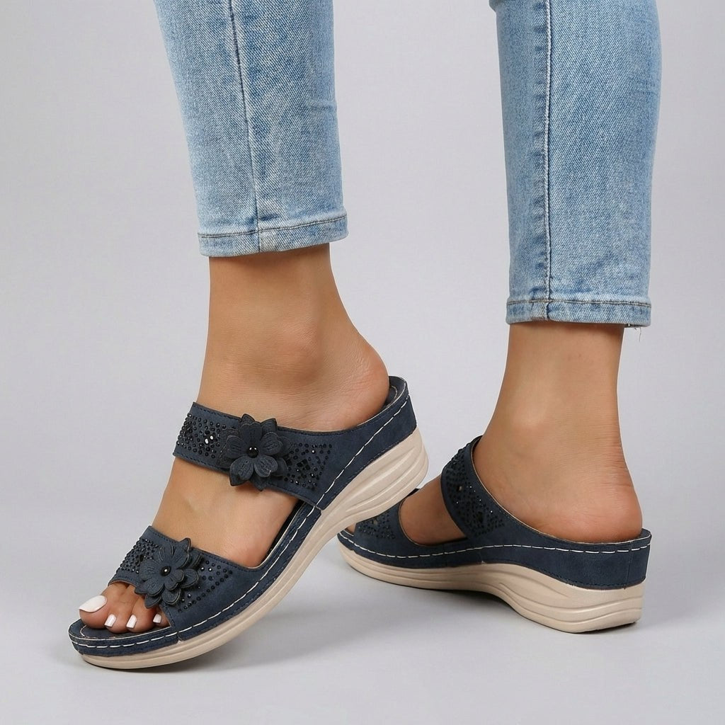 Blue floral strap wedge heeled sandals for women by Christine Brewer, featuring a stylish design and comfortable heel height.