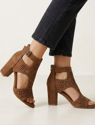 Brown Christine Brewer women's cut-out block-heel sandals with ankle buckle, showcasing stylish design and open toe detail.