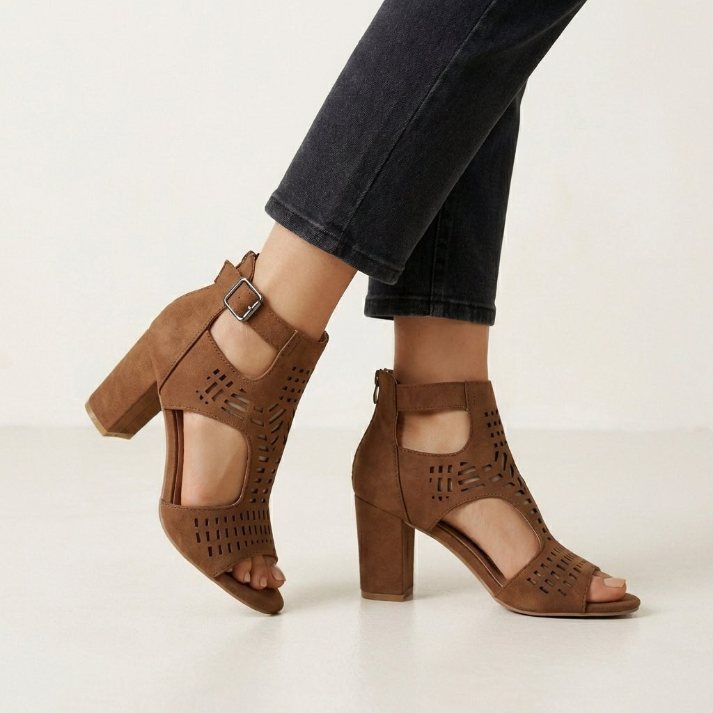 Brown Christine Brewer women's cut-out block-heel sandals with ankle buckle, showcasing stylish design and open toe detail.
