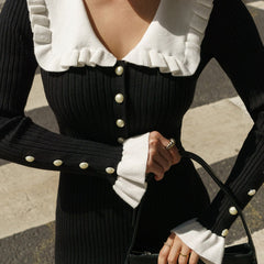 Black retro ruffled knit dress by Christine Brewer, featuring a fitted silhouette and stylish ruffle details.