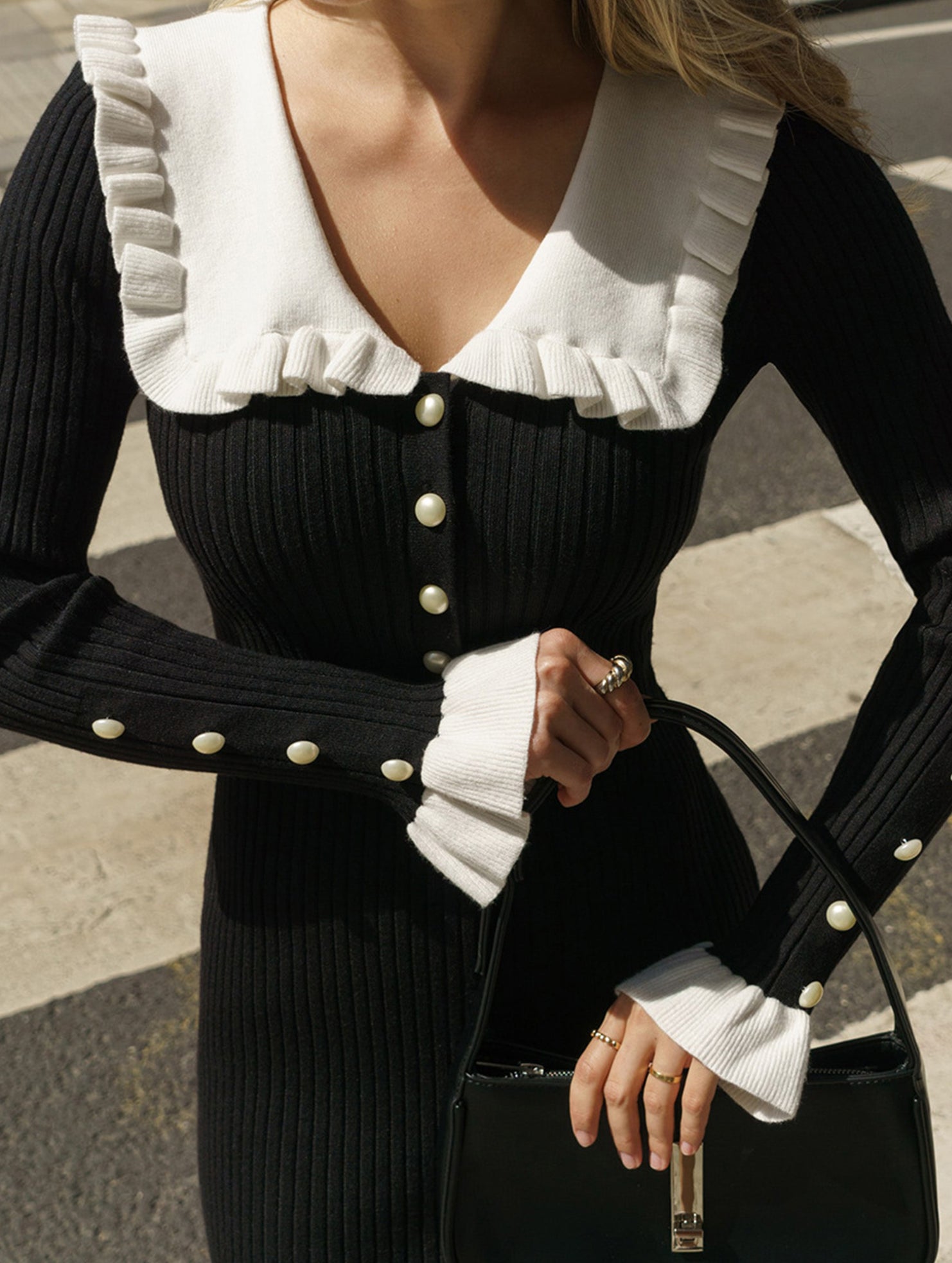 Black retro ruffled knit dress by Christine Brewer, featuring a fitted silhouette and stylish ruffle details.