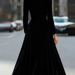 Black velvet round neck long-sleeved dress by Christine Brewer, displayed on a hanger with a smooth fabric finish.