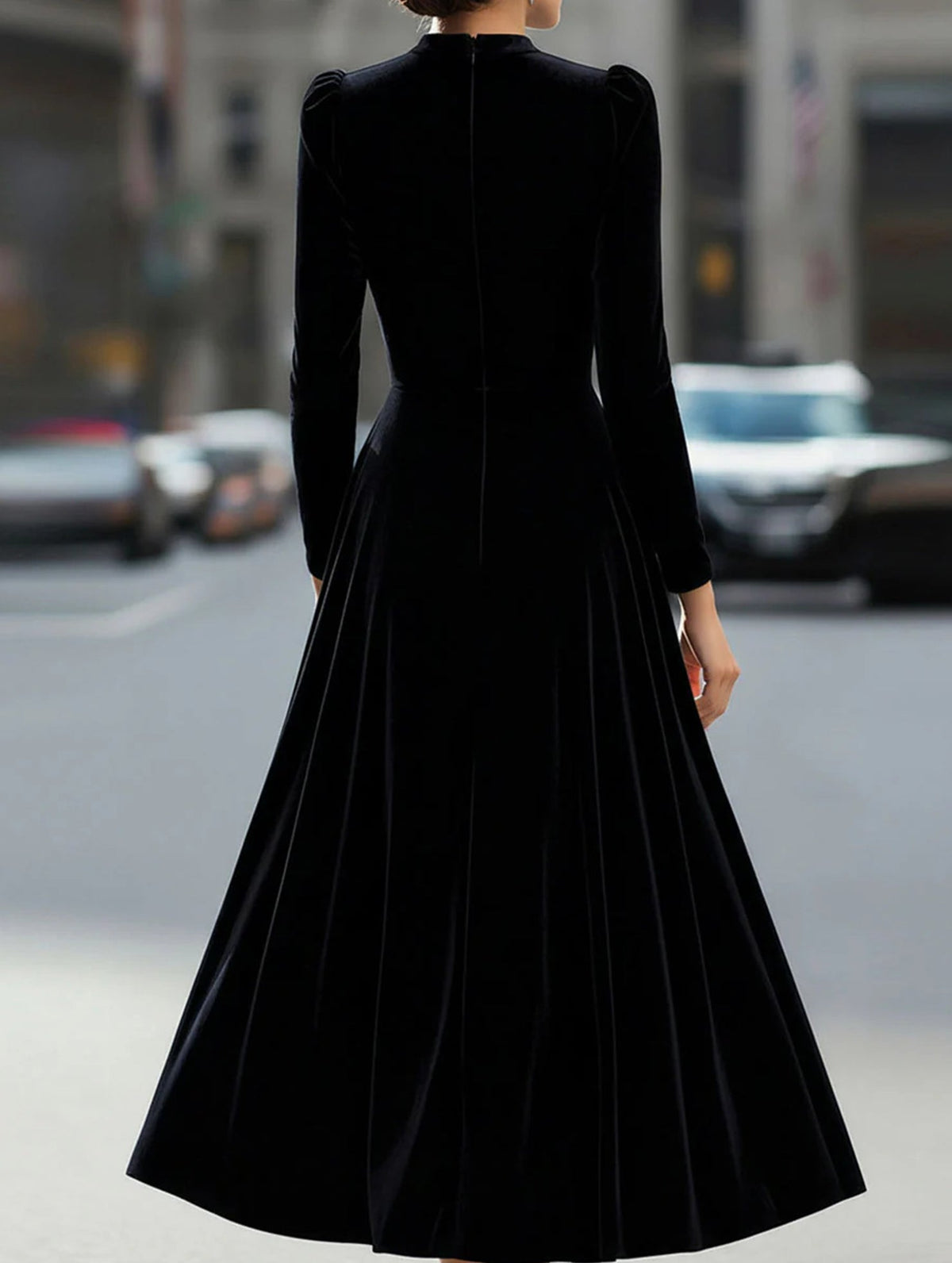 Black velvet round neck long-sleeved dress by Christine Brewer, displayed on a hanger with a smooth fabric finish.