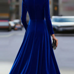 Blue velvet round neck long-sleeved dress by Christine Brewer, photographed on a model showcasing its elegant fit and fabric texture.