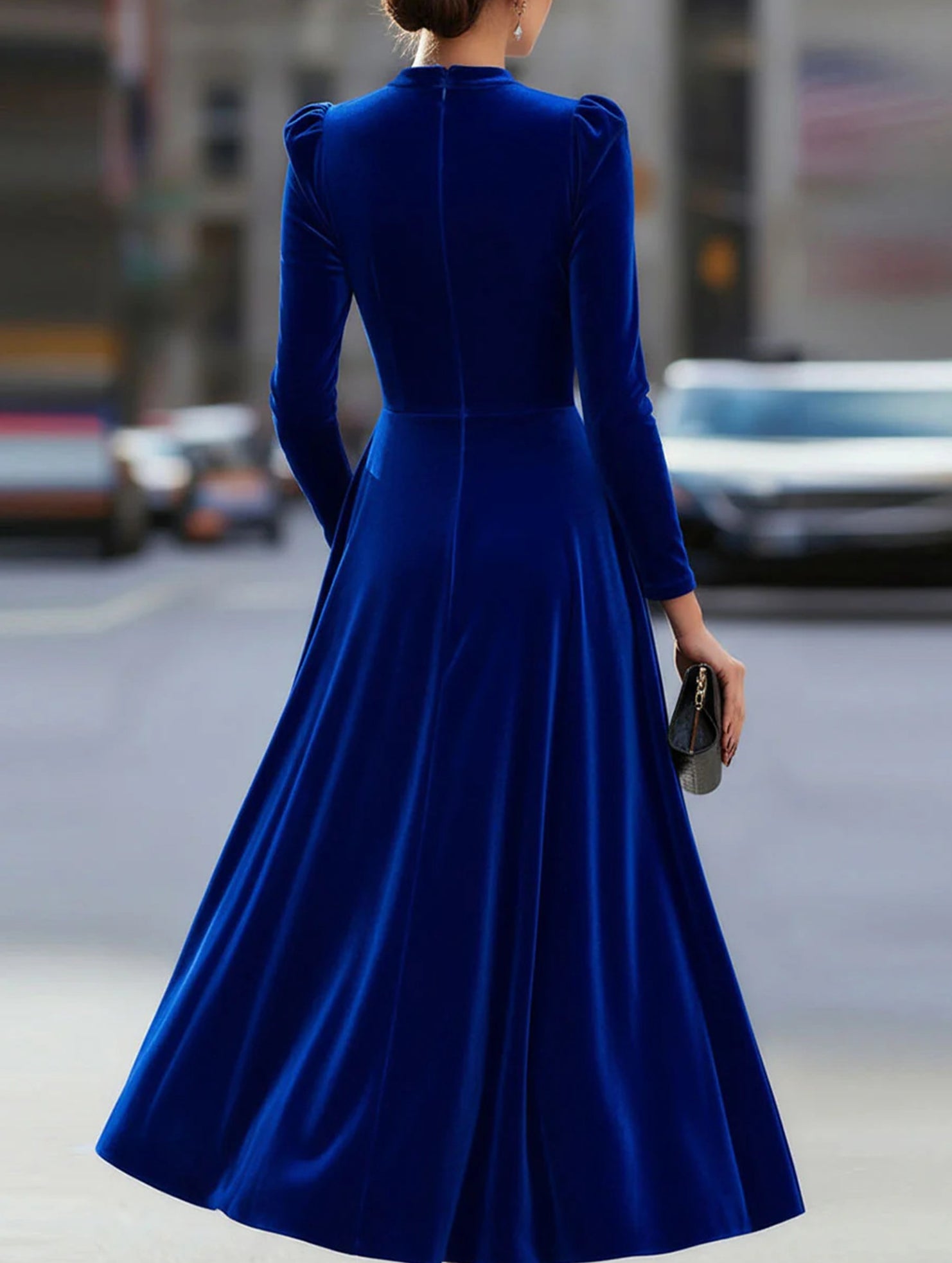 Blue velvet round neck long-sleeved dress by Christine Brewer, photographed on a model showcasing its elegant fit and fabric texture.
