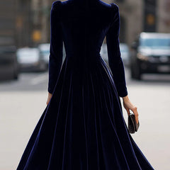 Navy velvet round neck long-sleeved dress by Christine Brewer, showcasing a fitted silhouette and soft fabric.