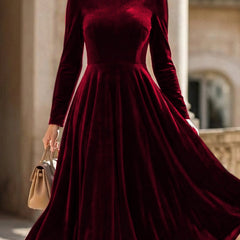 White velvet round neck long-sleeved dress by Christine Brewer, shown on a hanger against a plain background.