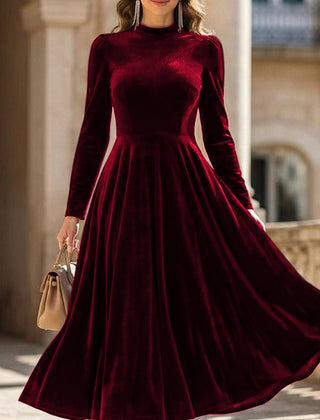 White velvet round neck long-sleeved dress by Christine Brewer, shown on a hanger against a plain background.