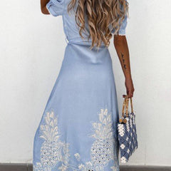 White pastoral style embroidered dress by Christine Brewer, featuring openwork details and a flowing silhouette.