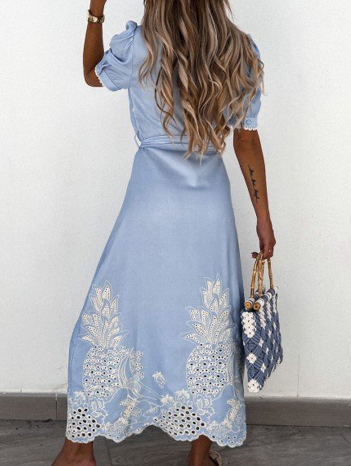 White pastoral style embroidered dress by Christine Brewer, featuring openwork details and a flowing silhouette.