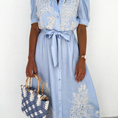 White embroidered dress with pastoral openwork design by Christine Brewer, featuring intricate embroidery and flowing fabric.