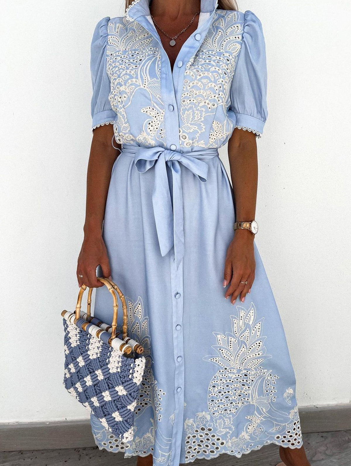 White embroidered dress with pastoral openwork design by Christine Brewer, featuring intricate embroidery and flowing fabric.